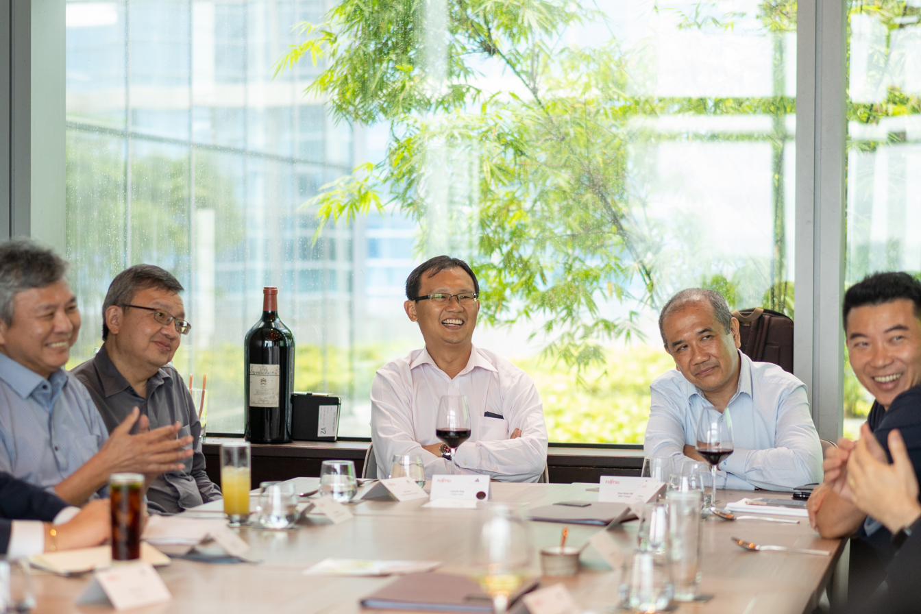 Senior leaders in discussion around a private dining table